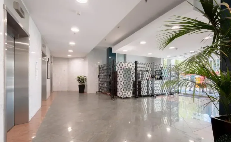 Ground-floor lobby of 161 London Circuit with lifts and plants
